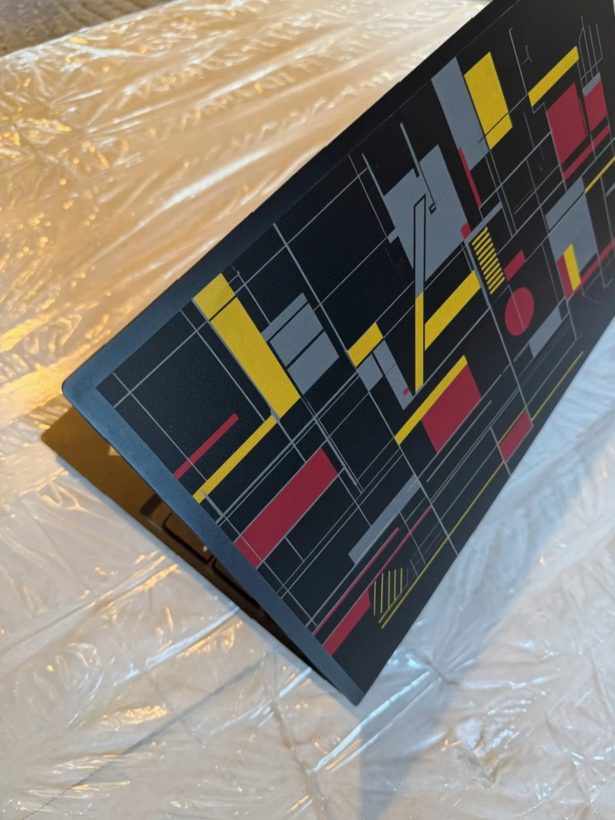 Custom printed laptop skin on an open laptop lid, seen from the side